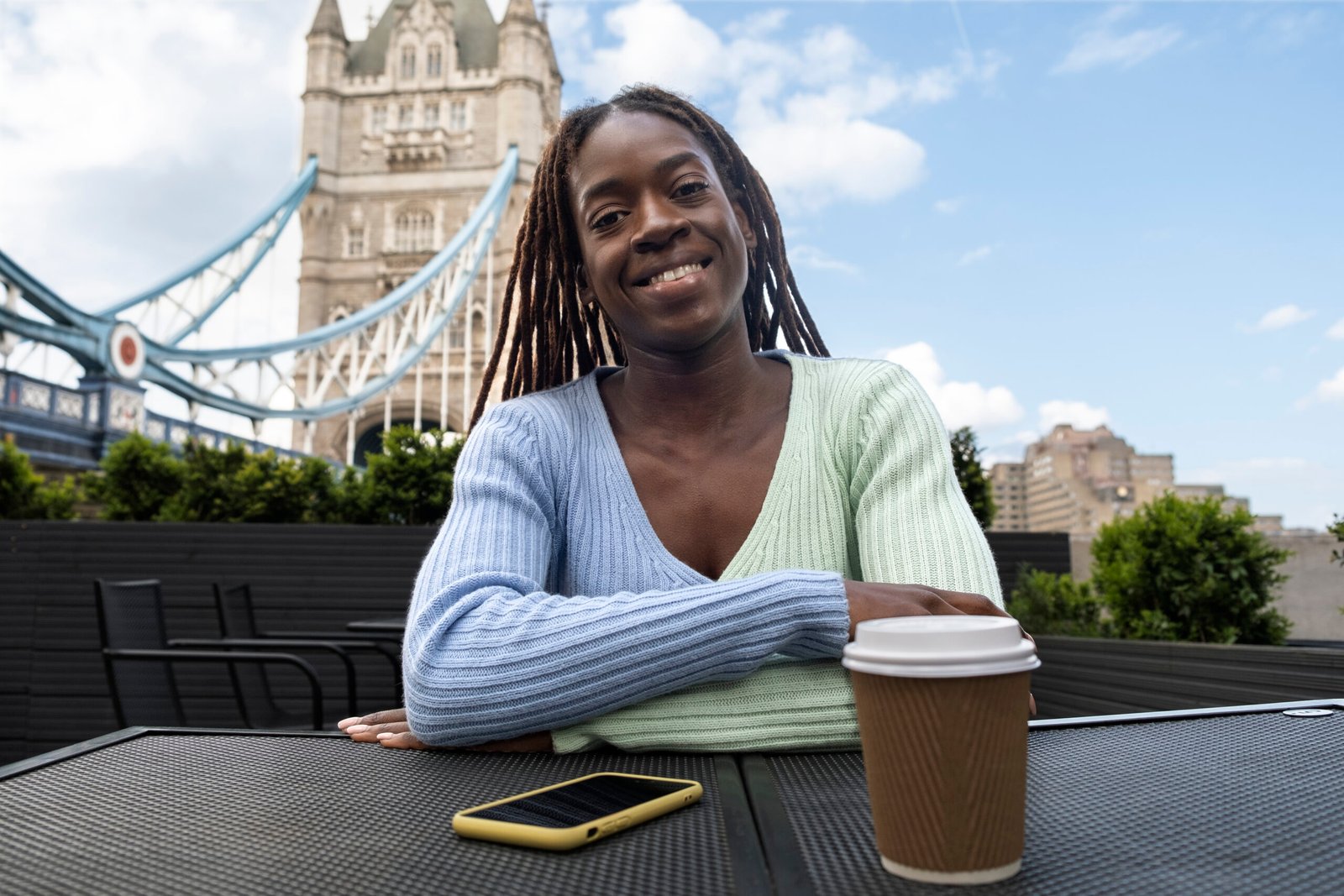 portrait young woman with afro dreadlocks city having coffee scaled