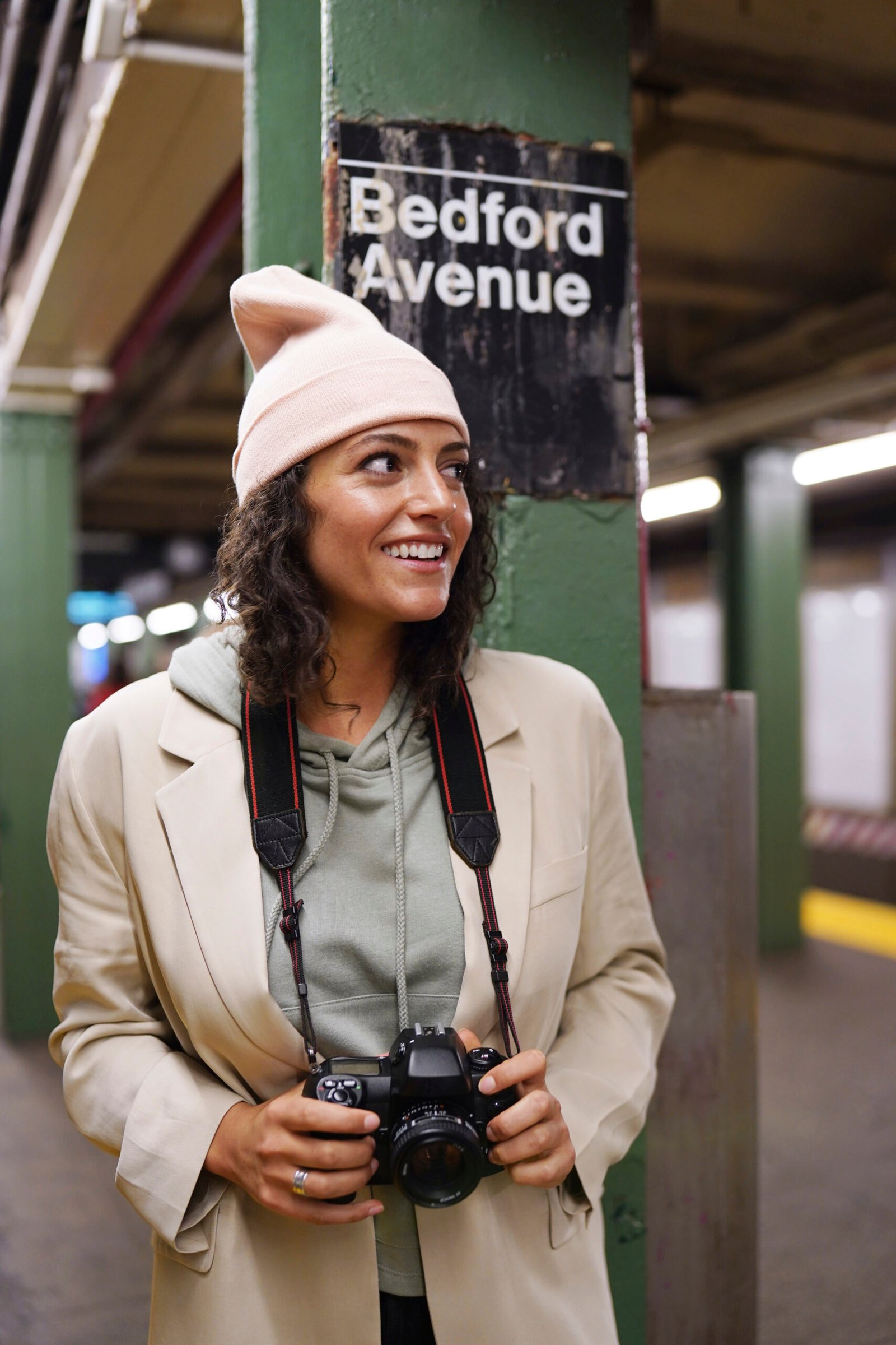young stylish female photographer exploring subway city scaled